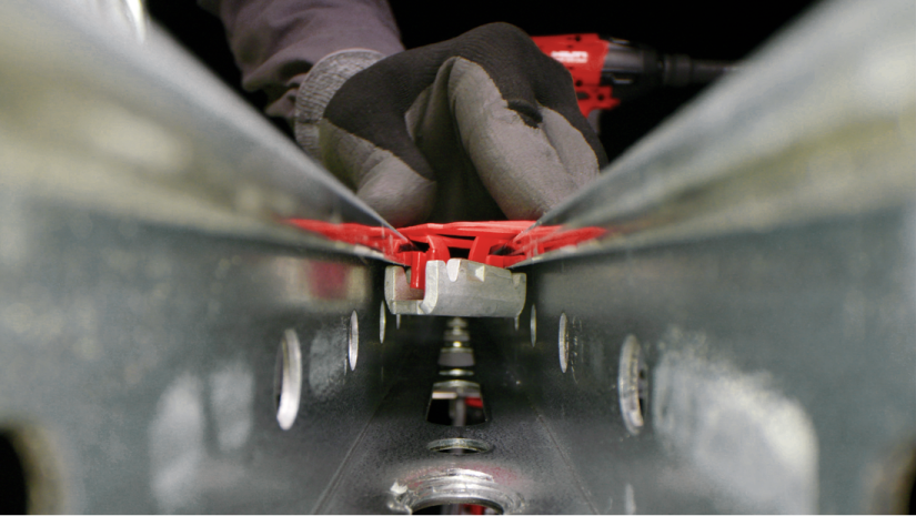 Close up of Hilti MT modular support channel. Above is hand in safety gloves.