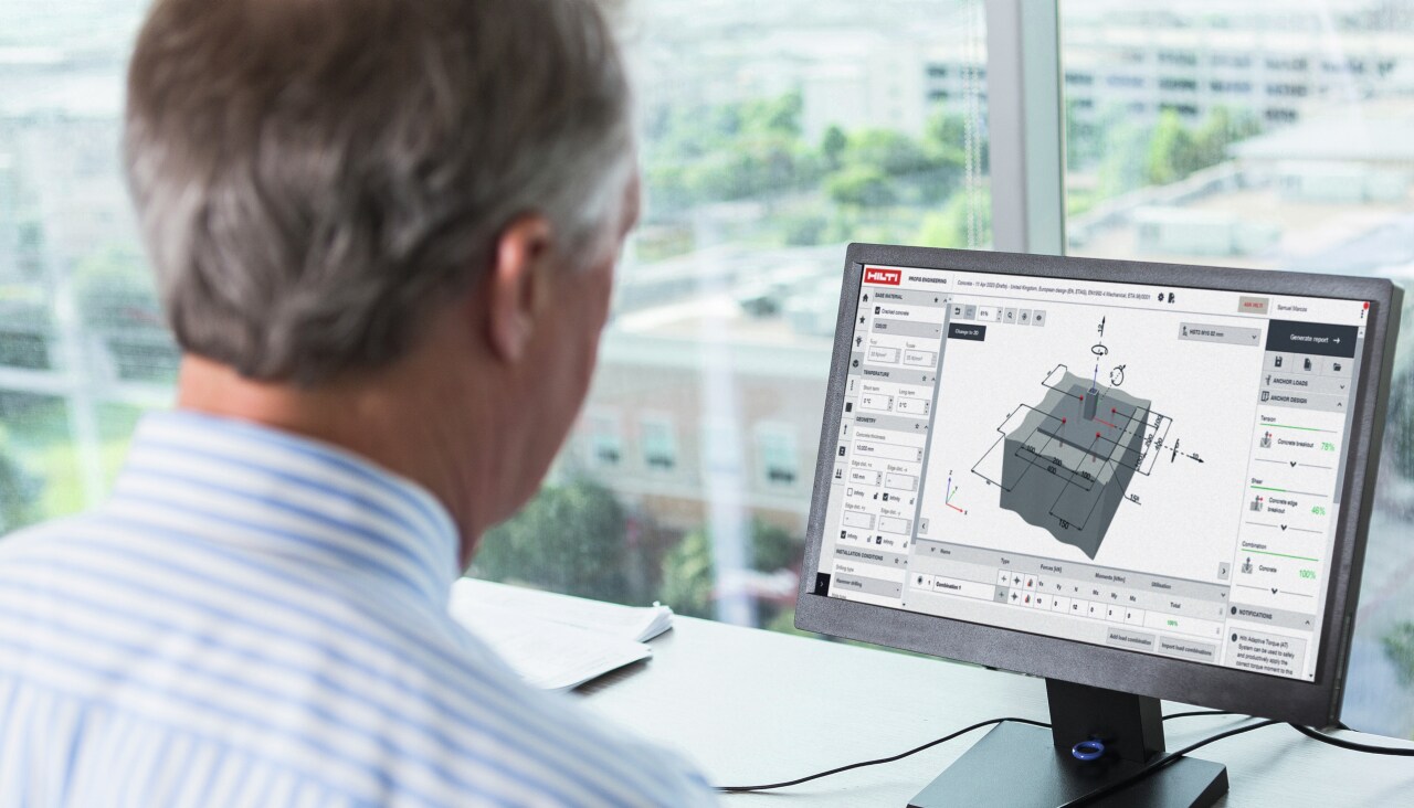 Man working on computer in office. On the screen is construction design software.