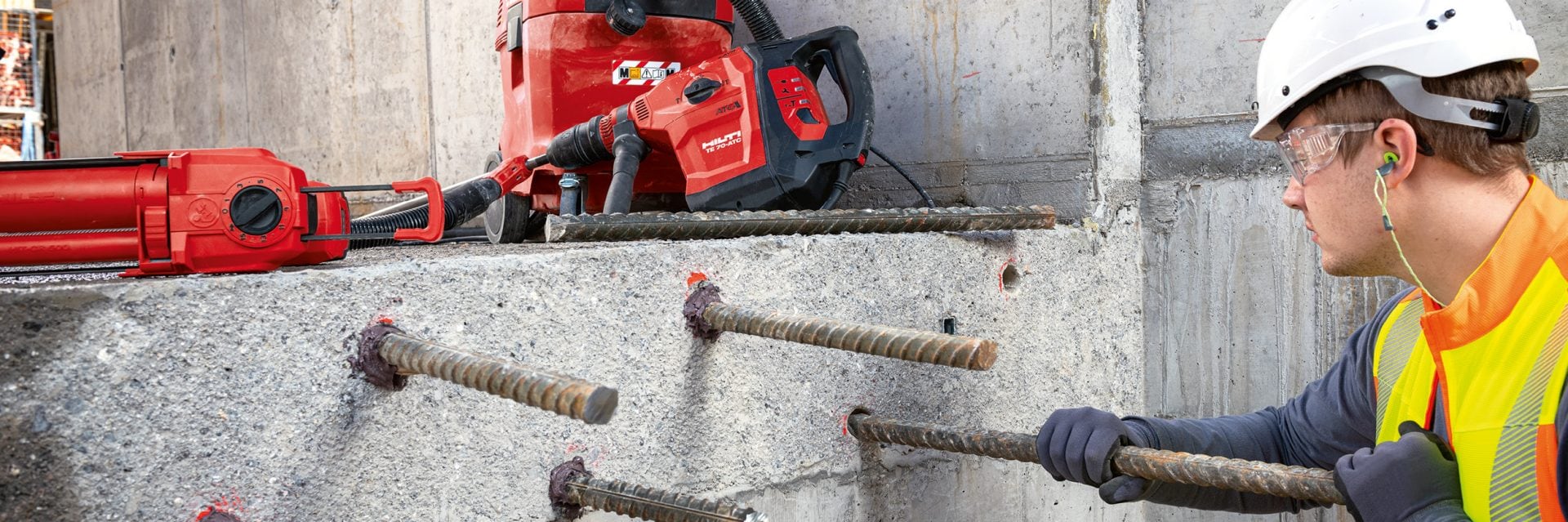 Man installing rebar connections with Red HIT-RE 500 V3 epoxy mortar.