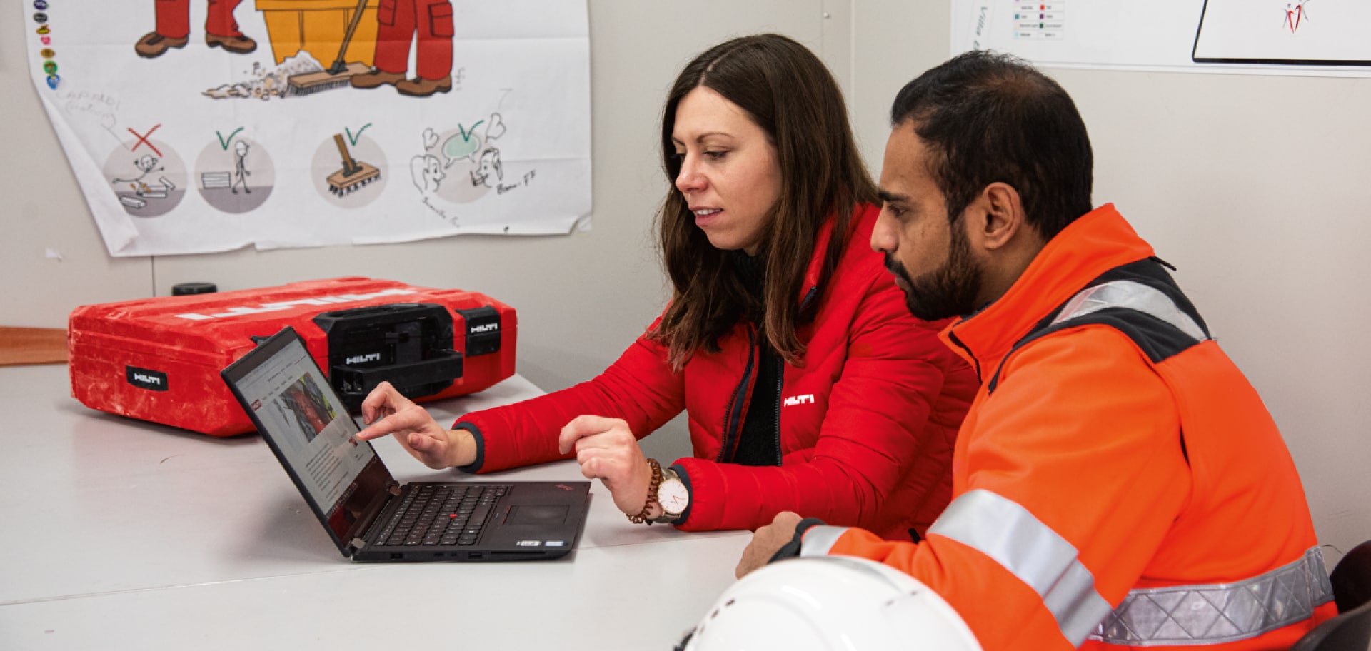 Hilti account manager talks to a customer in office.