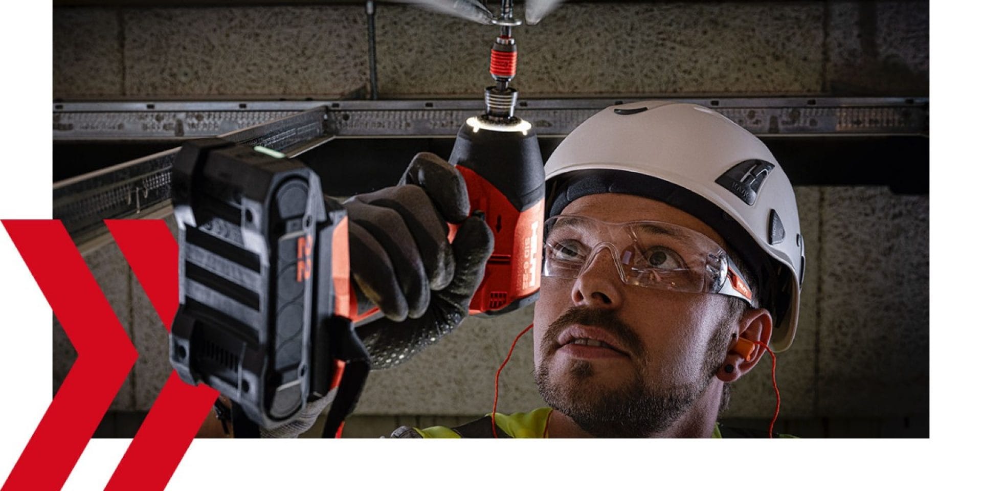 A person is doing overhead work with the Hilti Nuron SID 6-22 cordless impact driver and a B22-55 Nuron battery.