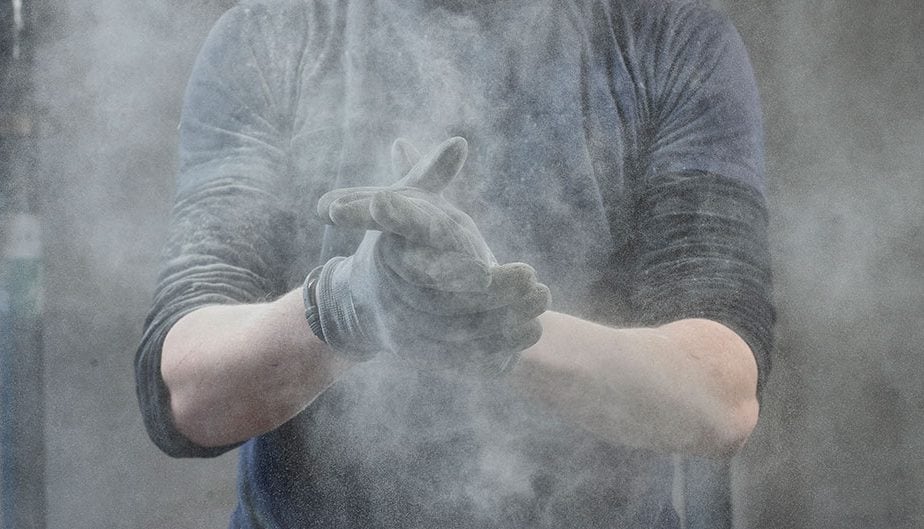 dust expelling from mans work gloves