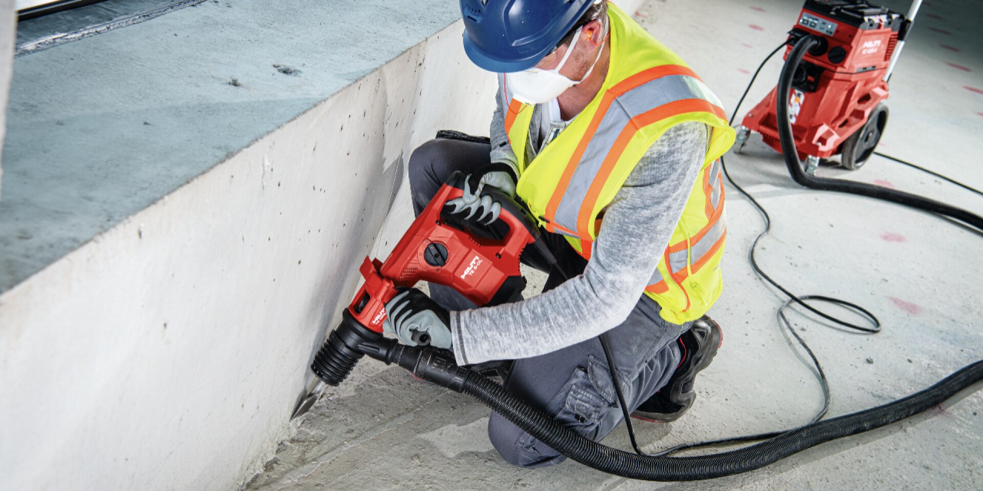 TE 2000-AVR concrete demolition hammer being used with a dust removal system and vacuum cleaner for virtually dust-free chiseling / breaking