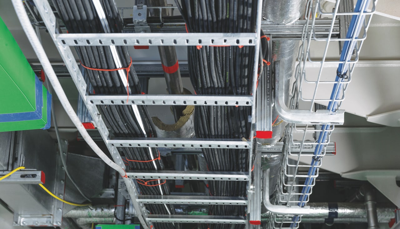 Hilti support system showing a metal frame, which holds cables routes tight to ceiling.