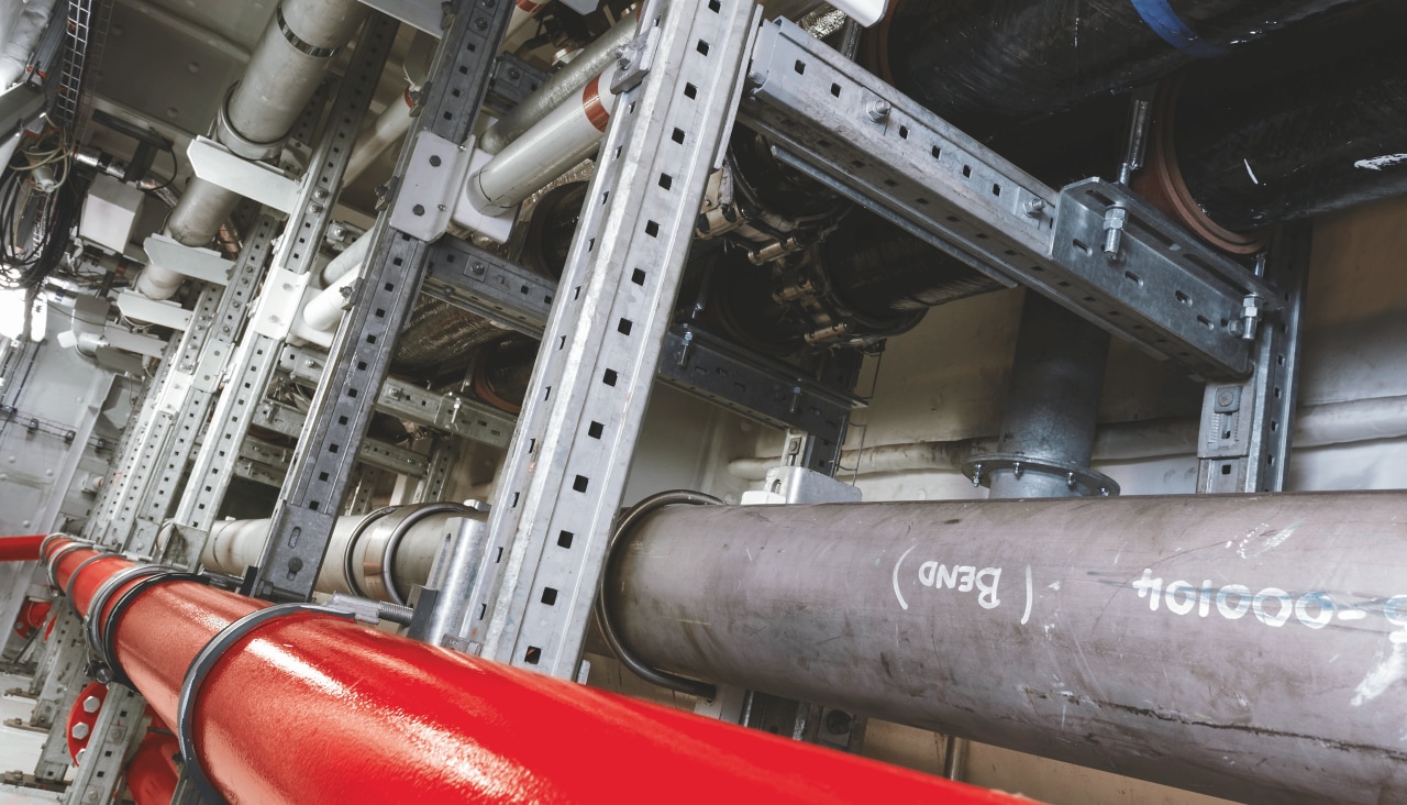 Large support systems holding a pipe route in a construction hall.