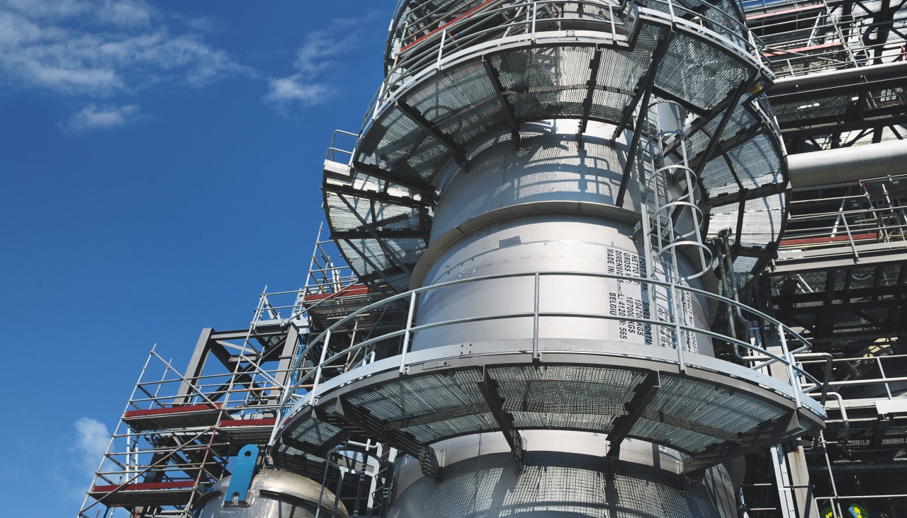 Large oil refinery plant under a blue sky.