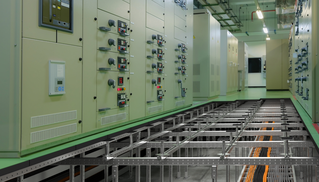 Raised floor system showing a data center room above a metal construction under which are cables and pipes.