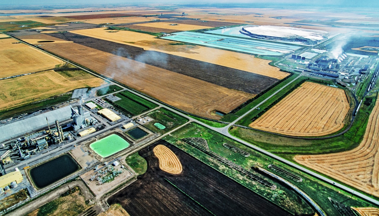 A drone picture showing two factories between agricultural fields.