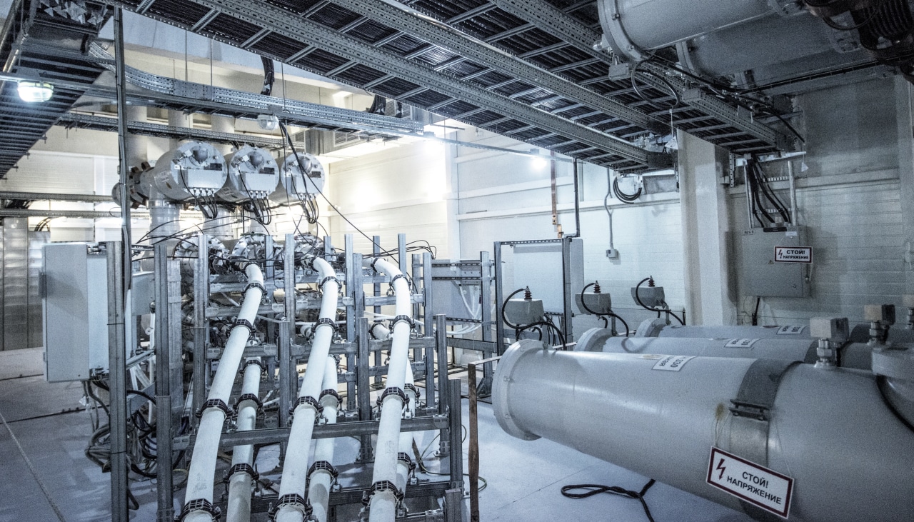 Cable management metal system construction holding flexible sleeves for cables in a power plant room.