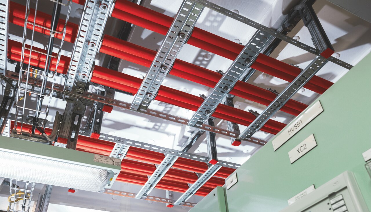 Cable tray and cable ladder supports close to ceiling in a technical room of petrochemical plant.Cable tray and cable ladder supports close to ceiling in a technical room of power plant.