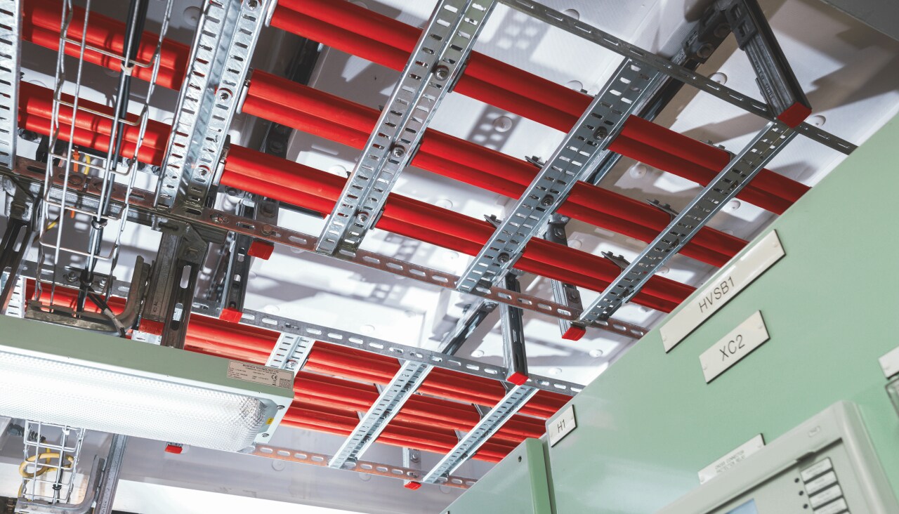 Cable management system - metal construction holding cables close to ceiling.