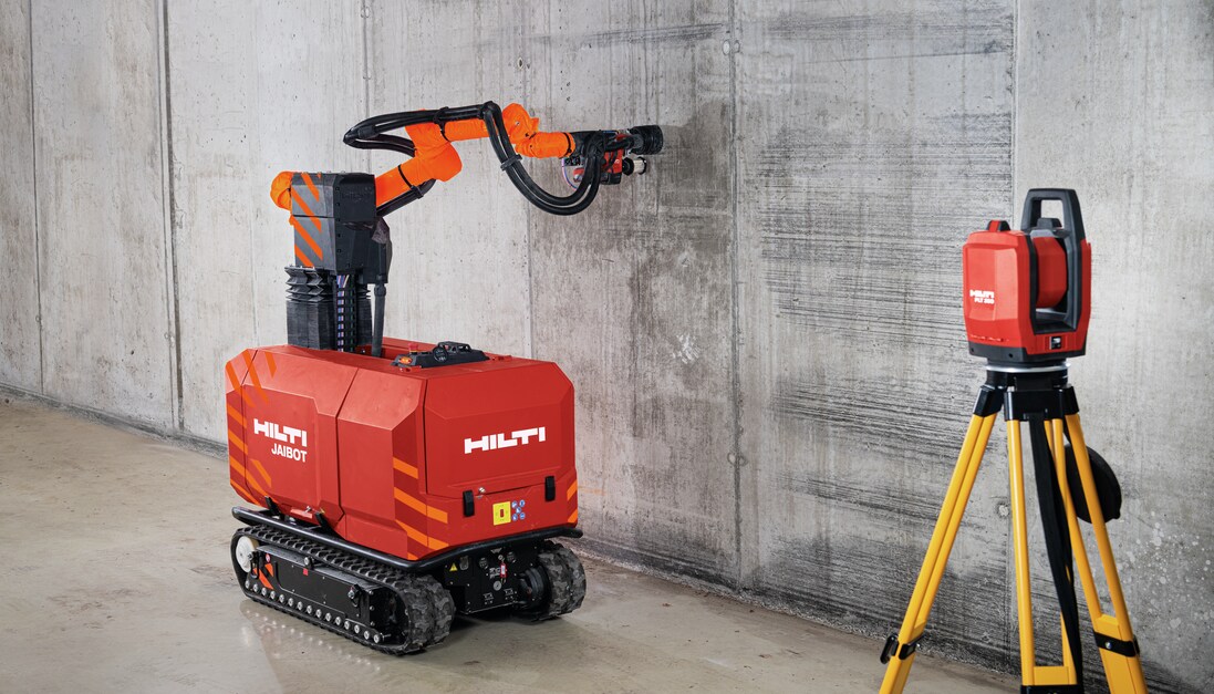 Concrete wall and construction robot drilling on a jobsite.