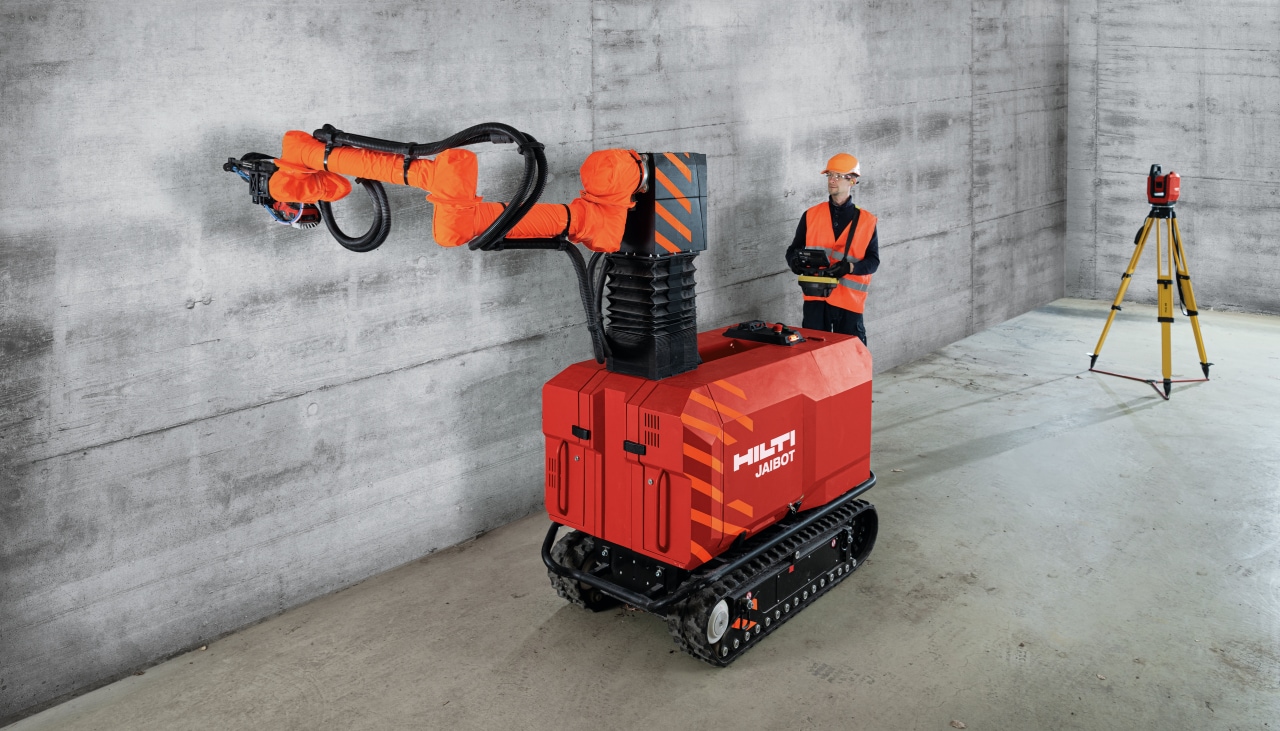 Hilti PLT 300 total station and Jaibot drilling robot on a construction site performing MEP installation.