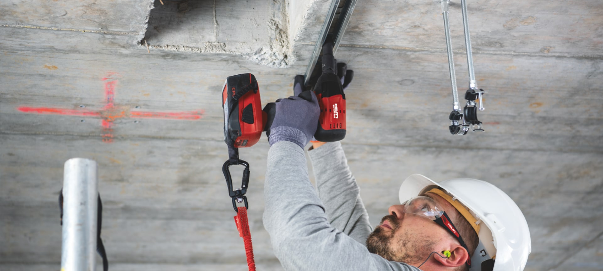Worker using a Hilti tool with a Hilti tool tether
