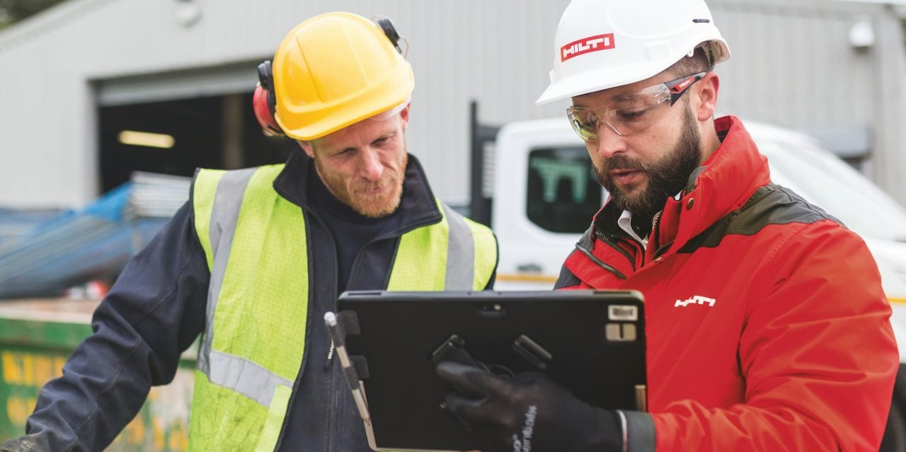 Hilti Account manager showing something on laptop to his customer.