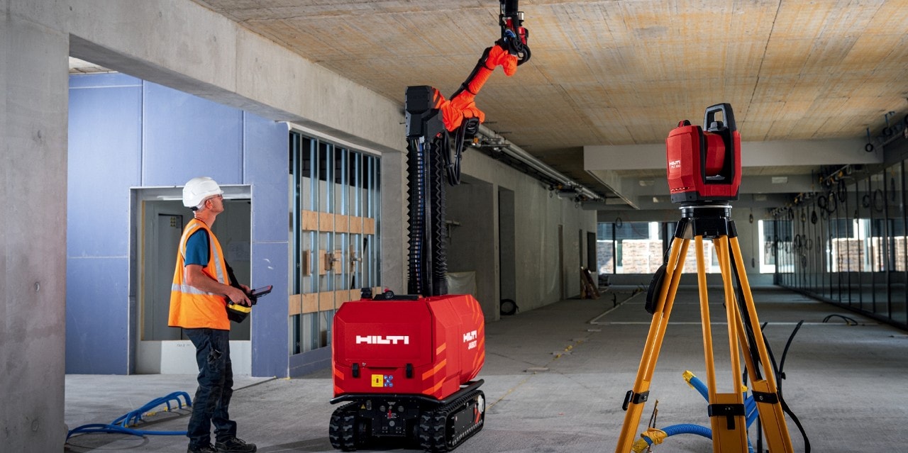 Man is directing Hilti Red Jailbot on tablet.