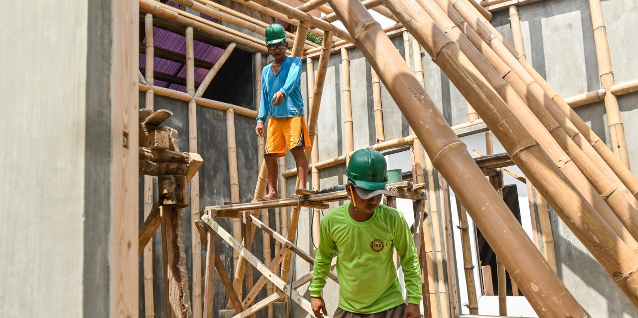 Workers build an orphanage using bamboo-cement technology in Batangas.