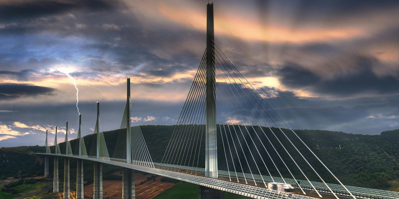 Construction worker in yellow high visibility vest holding Hilti red screw driver in hand. 