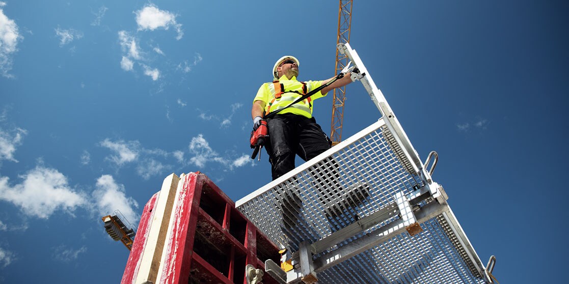 Hilti firestopping solotions, Man in a blue helmet takes picture of cables surrounded by firestops