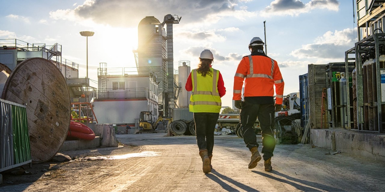 Hilti account manager walking with customer.