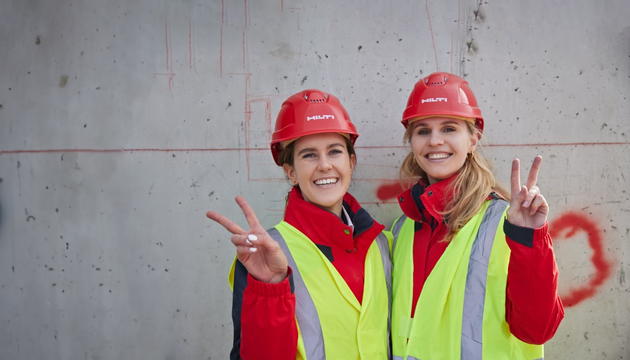 Two Hilti engineers smiling on a jobsite