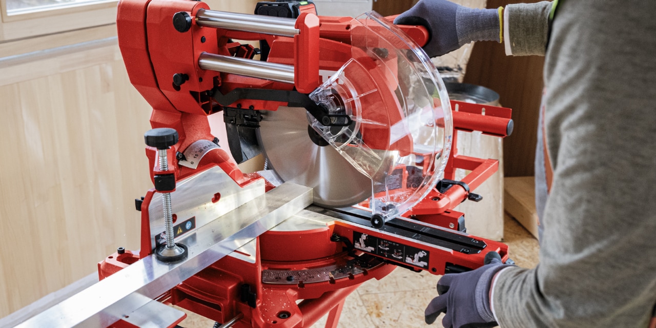 Man using red Hilti mitre saw.