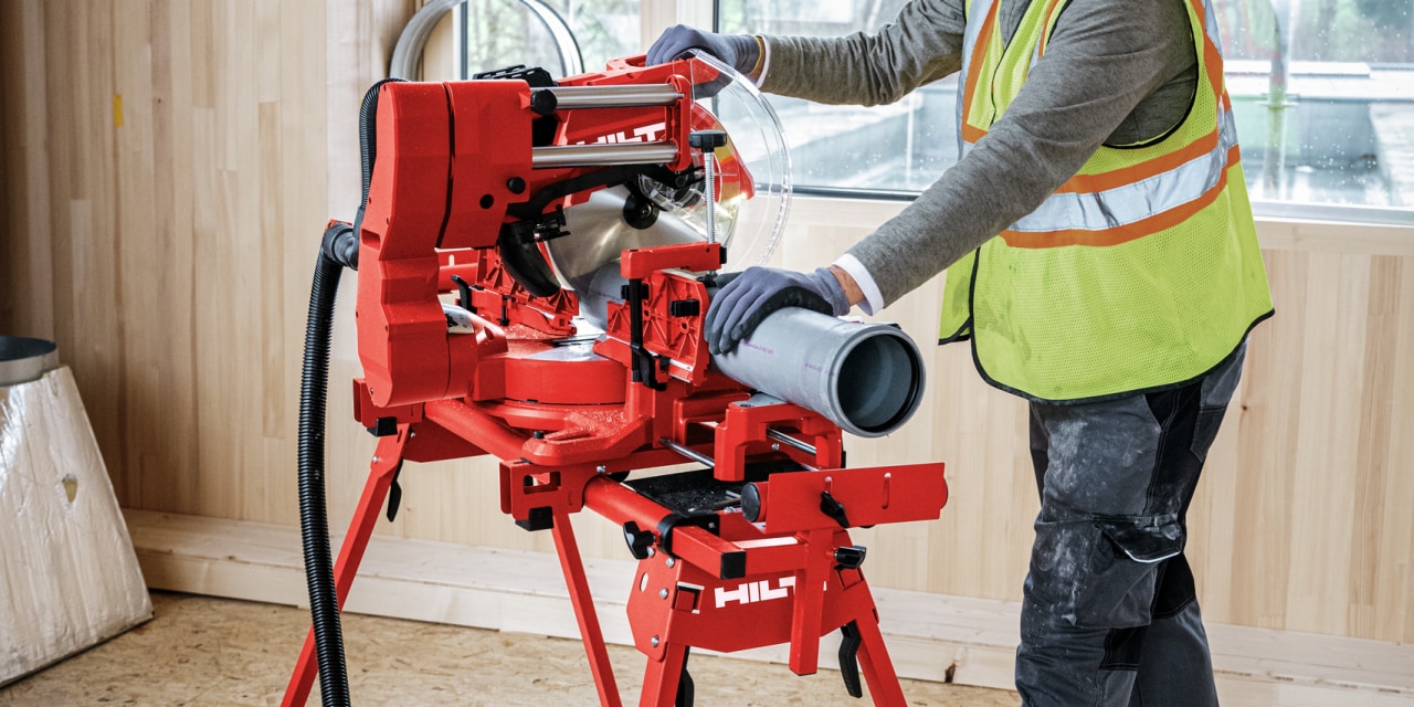 Man using red Hilti mitre saw.