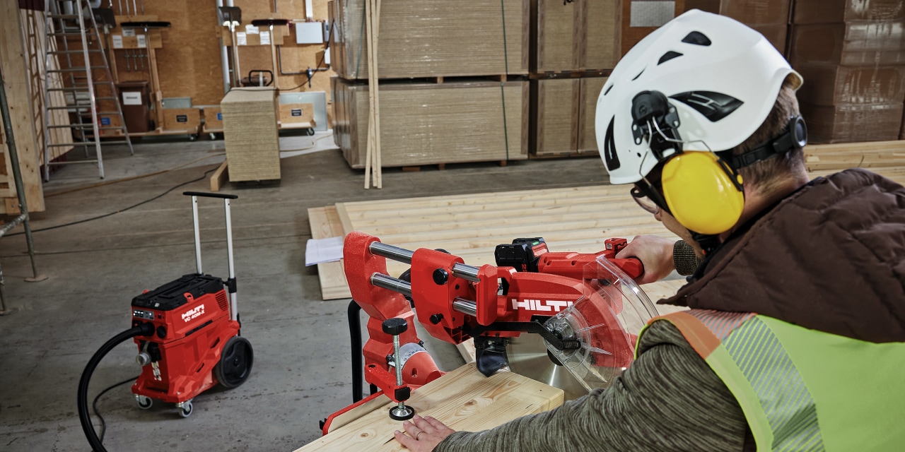 Man using red Hilti mitre saw.