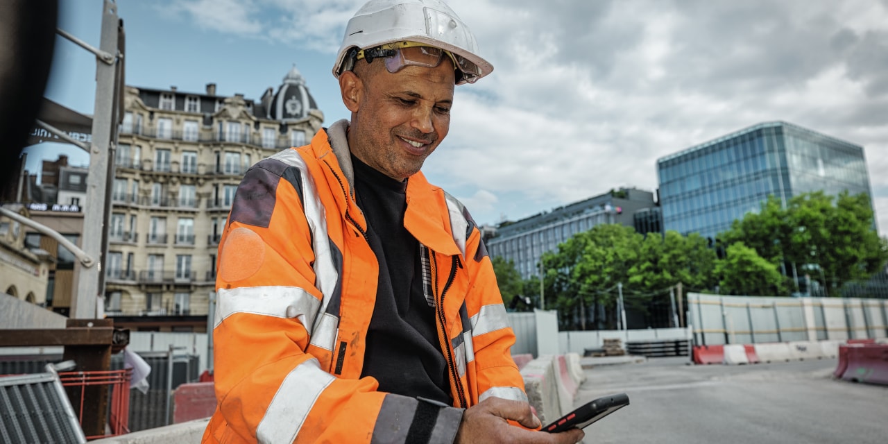 Construction worker using mobile phone.