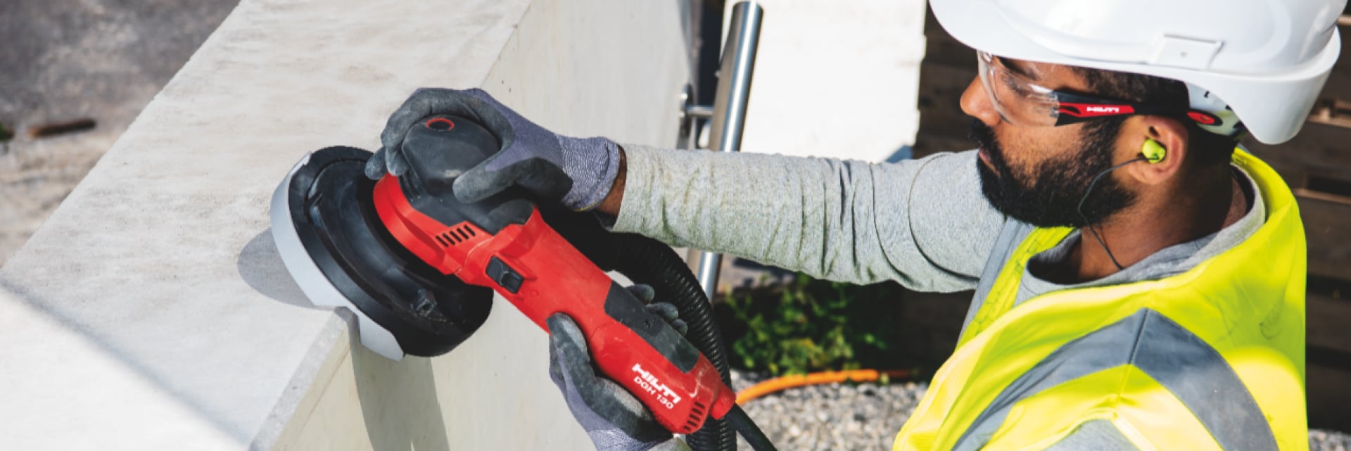 Man using Red Hilti Angle Grinder.