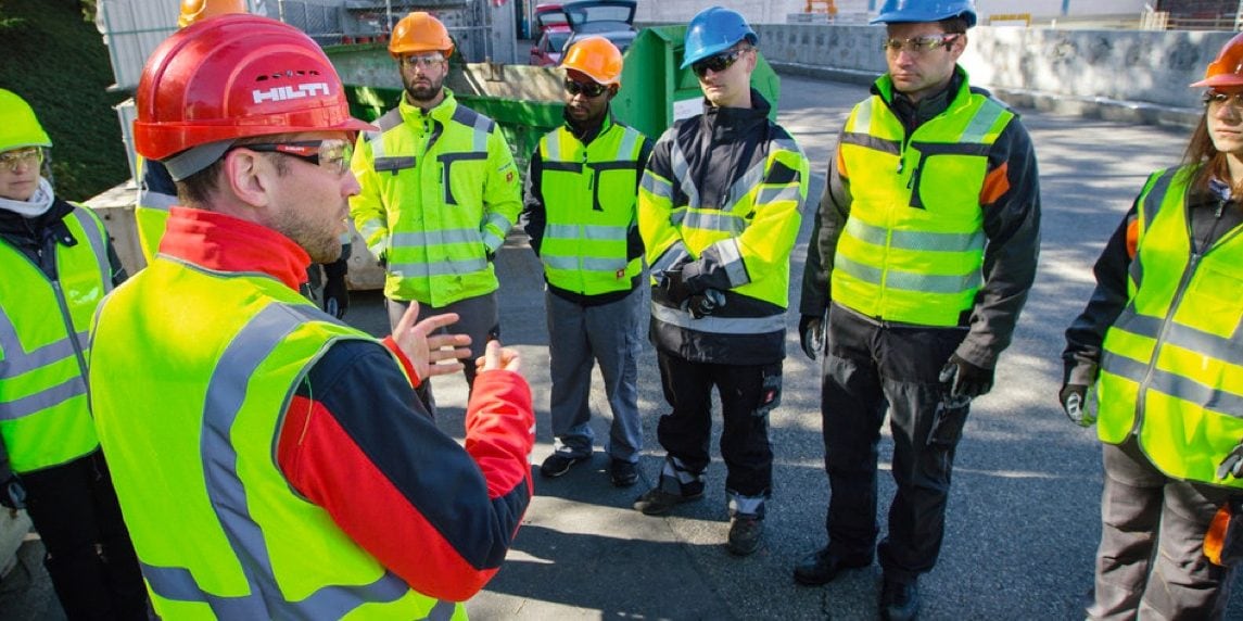 Group of construction workers having a chat with Hilti account manager. 