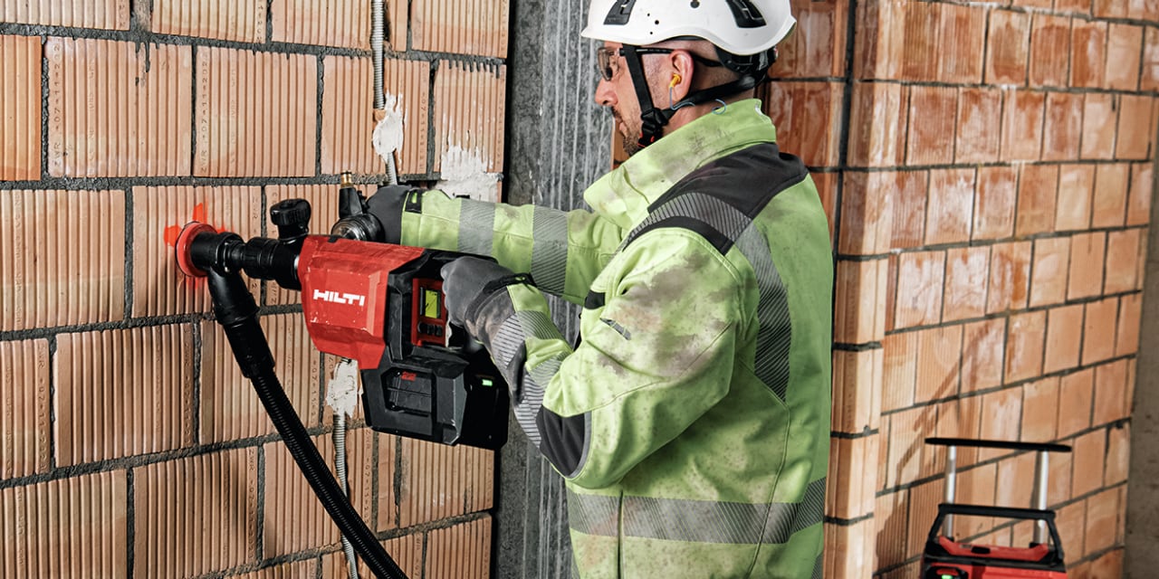 PERSON USING HILTI DIAMOND CORE DRILL