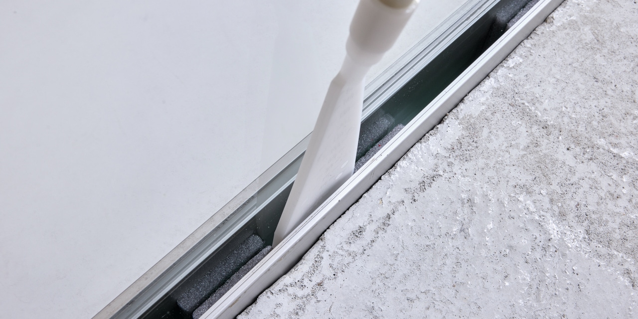 man injecting the foam into glass with Hilti's glass attachment
