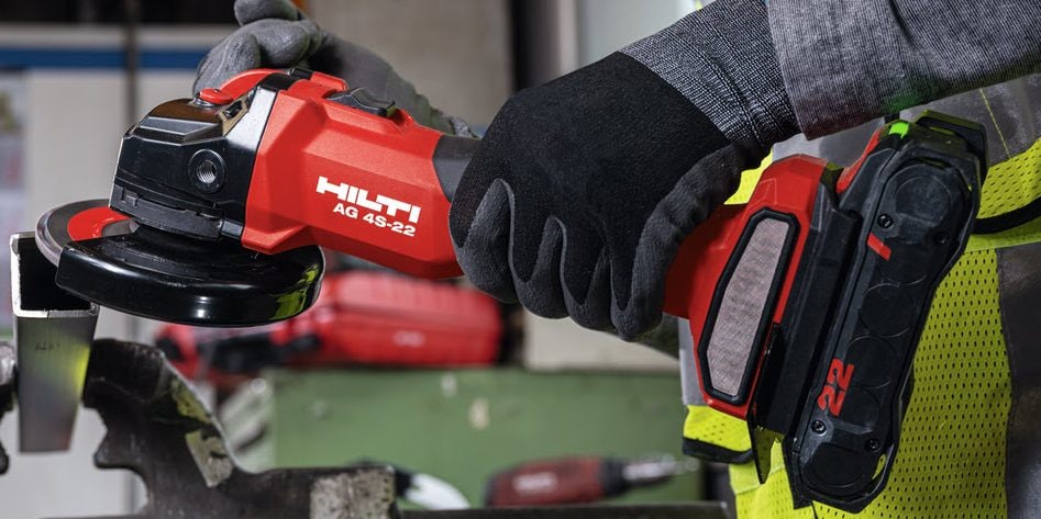 construction worker using Hilti angle grinder