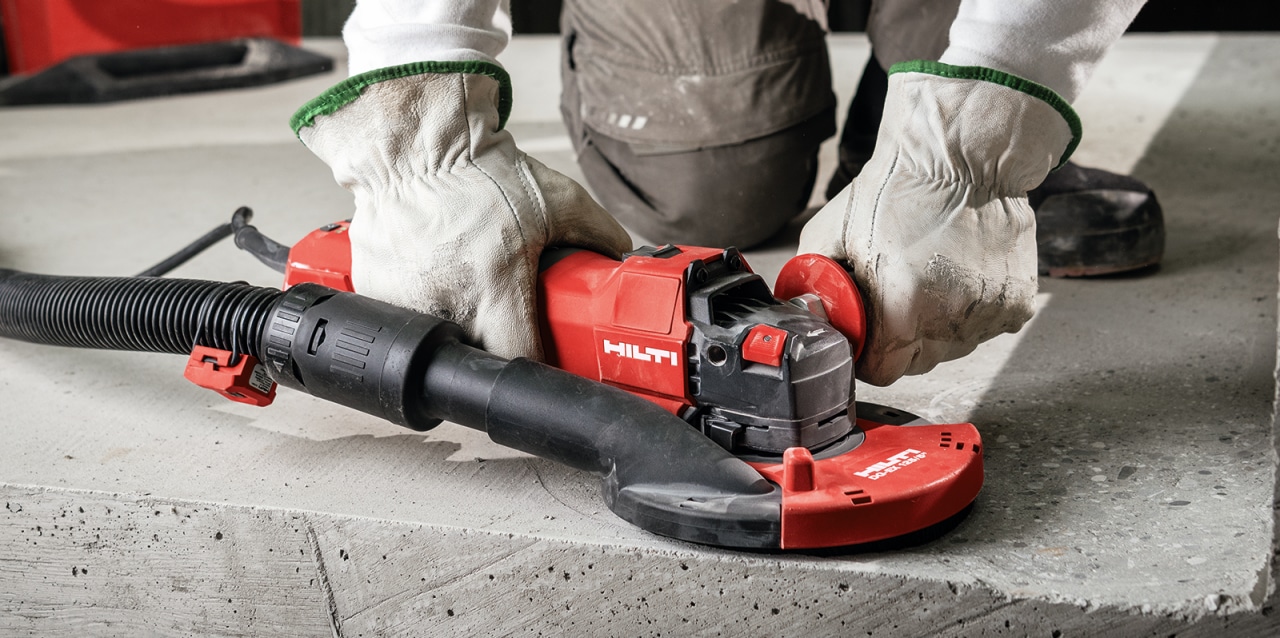construction worker using Hilti angle grinder