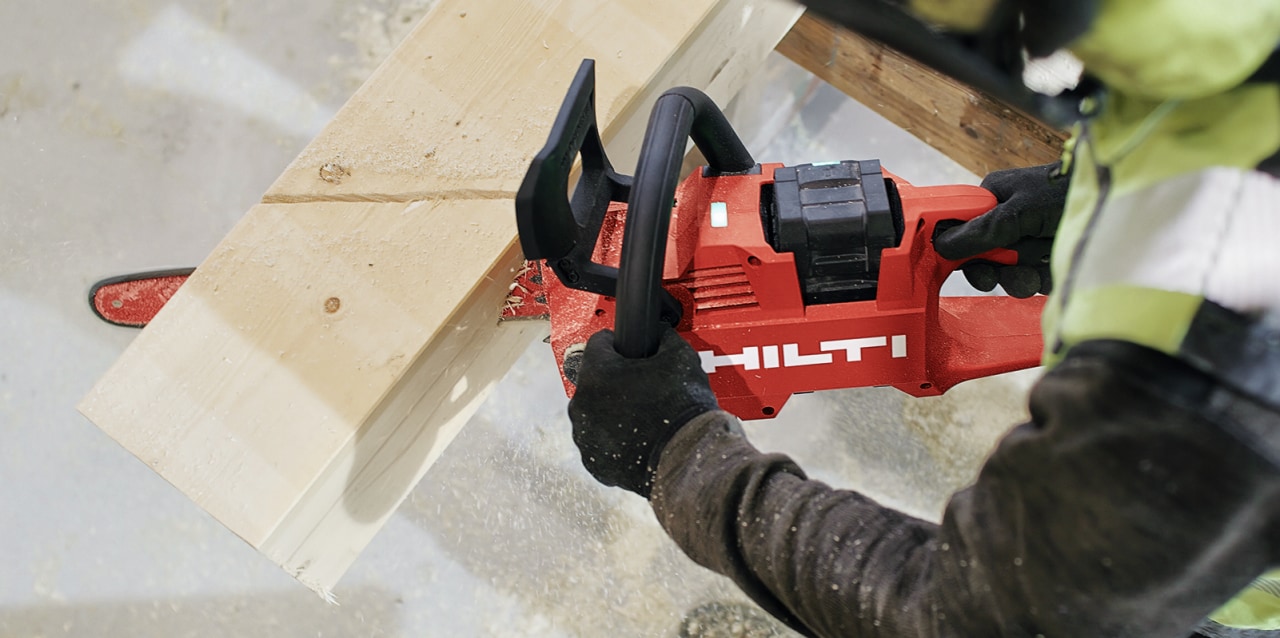 man using cordless chainsaw