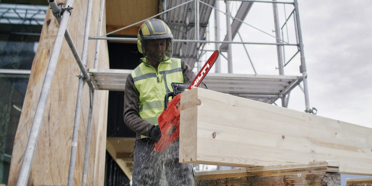 man using cordless chainsaw