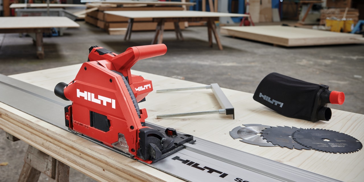 Close up of red Hilti plunge saw with leading rail and saw blades.